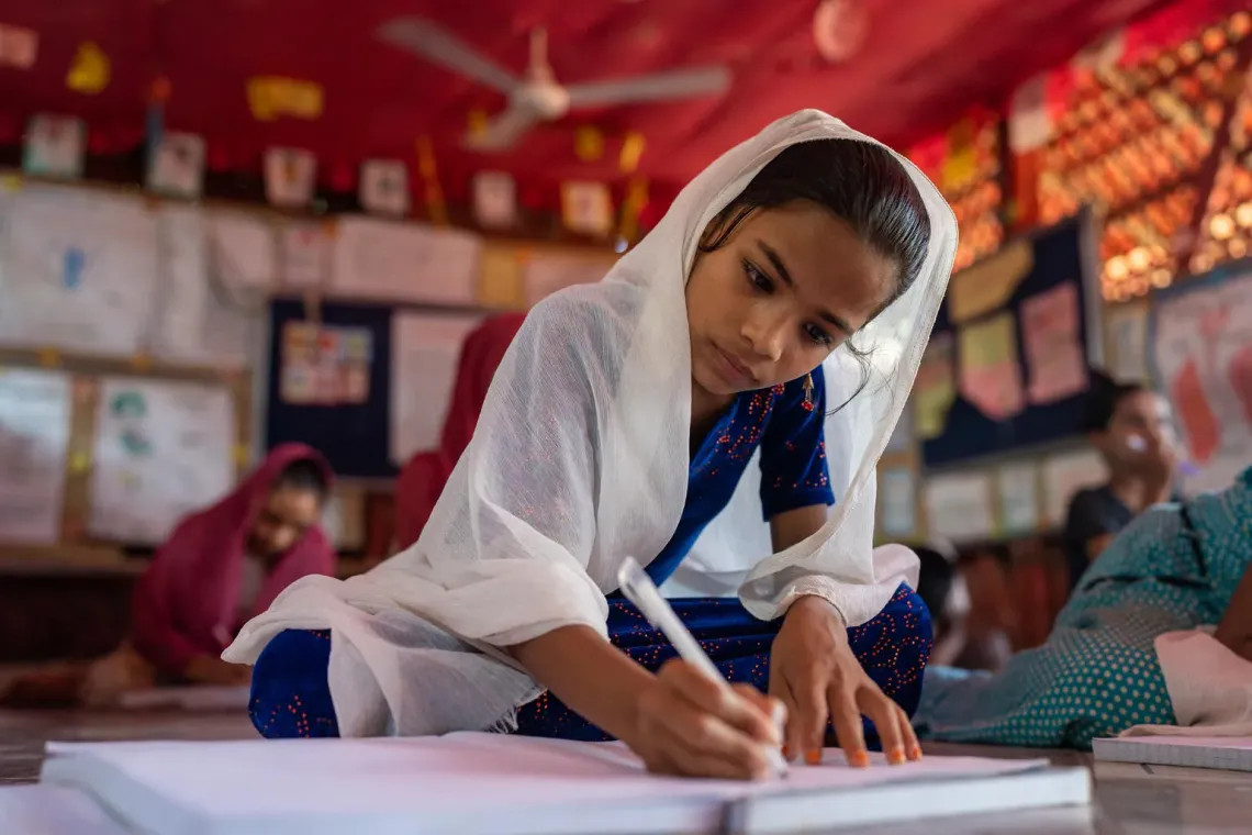 UNICEF/UNI866953 Una niña toma clase en un centro de aprendizaje en el campamento de refugiados Rohingyá en Cox's Bazar, Bangladesh.